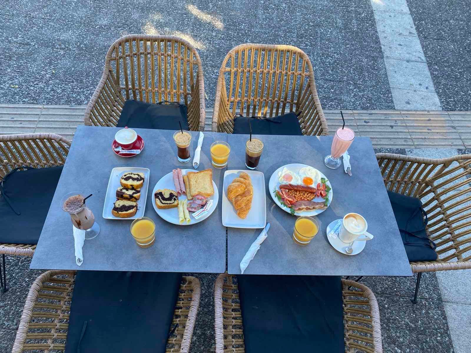 Breakfast plates, coffee and fresh juice served at Sintrivani cafe in Kos Town